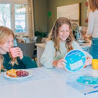 Child using the French Verbs Wheel at home